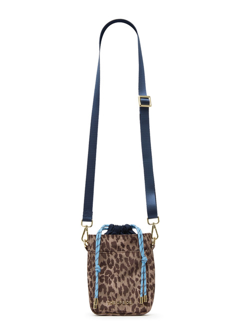 THE UPSIDE women's animal recycled polyester Panthera Anyday Crossbody Bag features an internal drawstring opening, front slip pocket and adjustable navy strap. Made for lifestyle.