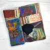 Assorted precut fabric pack with batik and multicolor pieces in a clear bag