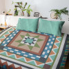 Medallion Magic quilt displayed on a bed with coordinating pillows