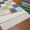 Crib-size cotton poly batting layered beneath a blue floral quilt
