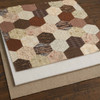 Twin-size cotton poly batting layered beneath a brown hexagon quilt