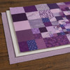 Queen-size cotton poly batting layered beneath a purple patchwork quilt