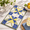 Lemon Blossom Quilter's Muse bundle shown as a blue, yellow, and green table runner