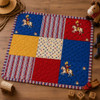 Playtime fabric bundle shown as a finished red, blue, and gold patchwork mat