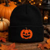 Smiling jack-o-lantern embroidery on black knit beanie