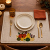 Pumpkin and gourd embroidery on cream placemat in fall table setting
