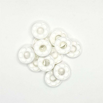 White plastic Madeira thread spool caps grouped on a white background