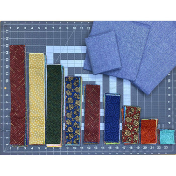 Bold and Beautiful Log Cabin Quilt Kit fabrics in blue and earth tones