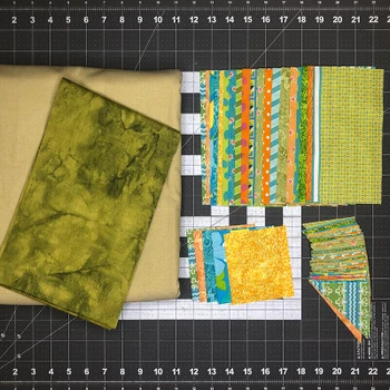 Sunkist Pinwheel Star Quilt Kit fabrics and pieces on cutting mat
