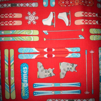 Red ski-themed fabric with skis, boots, poles, and winter gear
