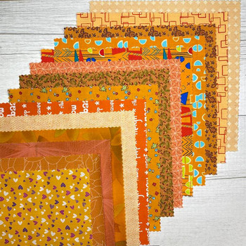 Stack of Orange 10-inch precut fabric squares