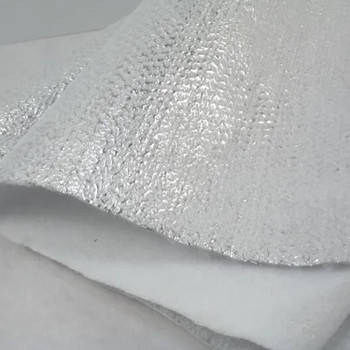 White insulated fleece quilting stabilizer showing reflective foil and soft batting layers