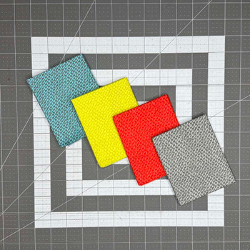 Punctuated fat quarters in teal, yellow, red, and gray patterns