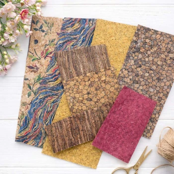 Cork fabric grab bag assortment spread out in natural, gold, red, and printed textures