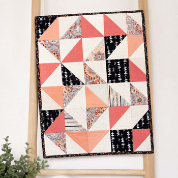 Midnight Blush fabric bundle shown as a finished geometric wall quilt