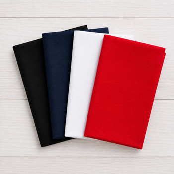 Red, white, and blue four-piece fat quarter bundle folded on white wood background