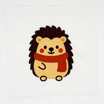 Cute hedgehog embroidery wearing a rust orange scarf