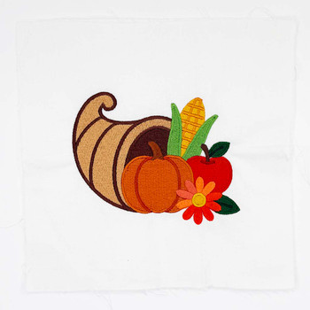 Harvest cornucopia embroidery design with pumpkin, corn, apple, and flower