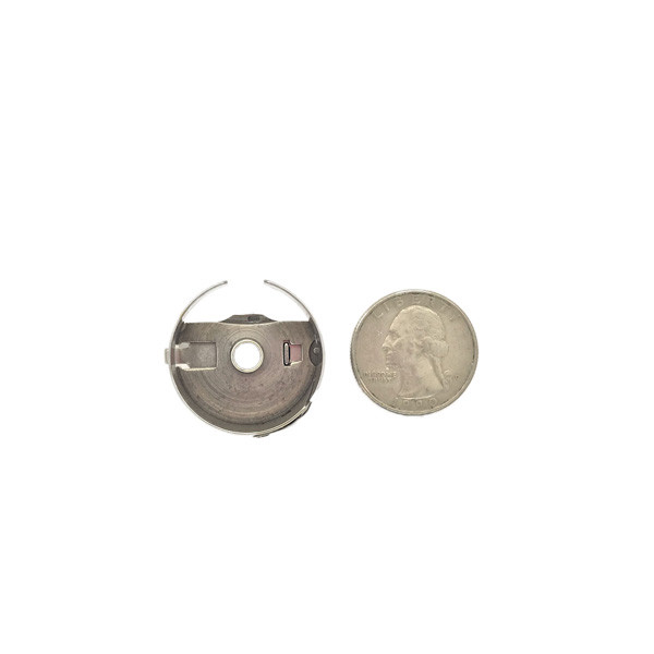 Bobbin Case - Style M product shown for scale and identification