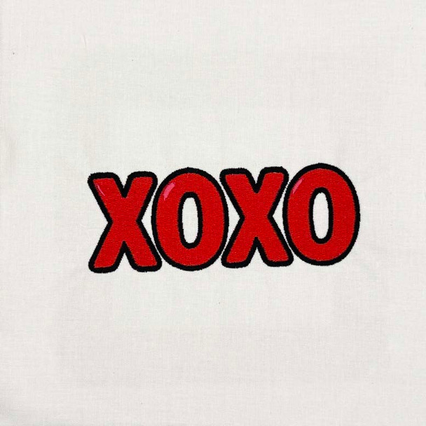 XOXO Valentine machine embroidery design stitched in red with black outline on white fabric