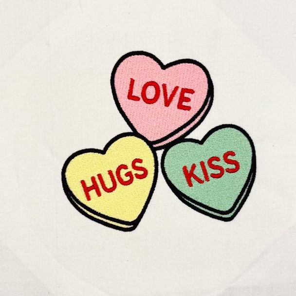 Love Hugs Kiss candy hearts machine embroidery design stitched on white fabric