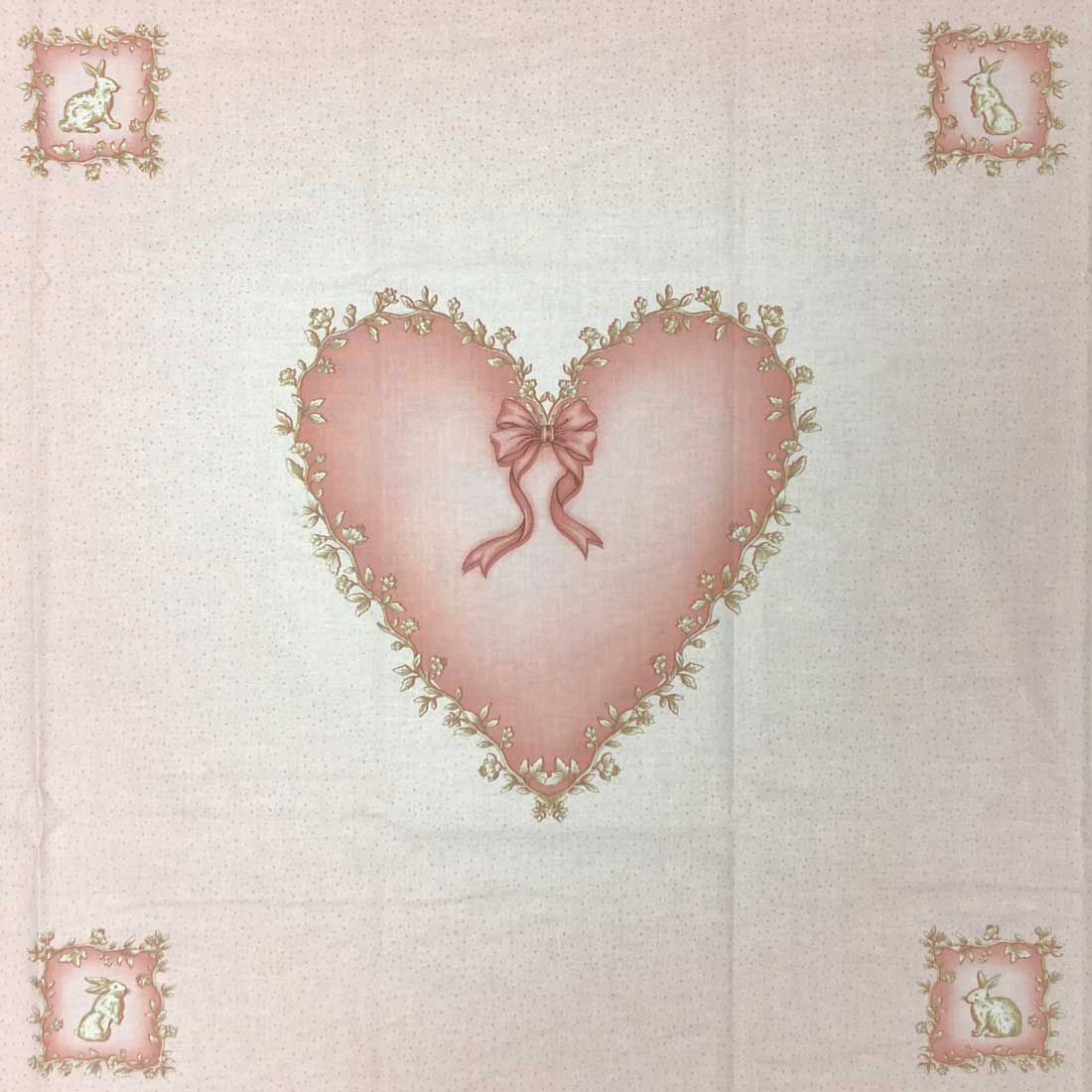 A piece of fabric with a heart and four rabbits on it