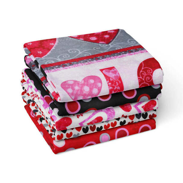 A stack of five Valentine’s Day themed fabrics