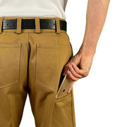 Man wearing CCW Breakaways concealed carry HONEY GOLD JEANS shorts using the cell phone pocket to access his mobile phone.