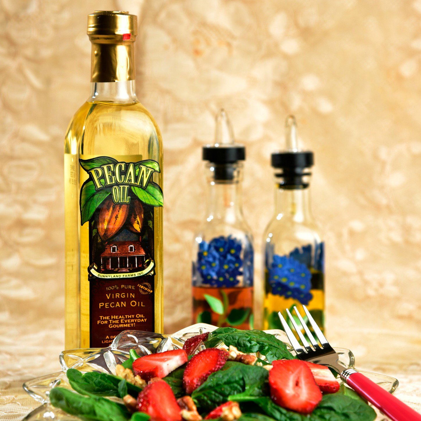 Pecan oil with two vinaigrette bottles and a summer salad
