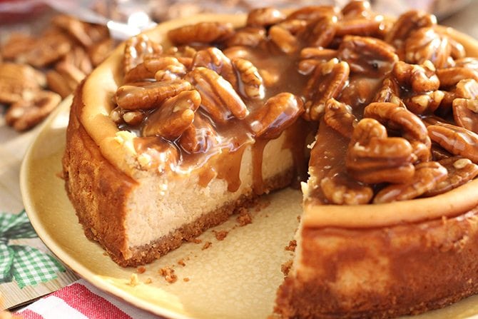 Close-up image of a cut caramel pecan cheesecake
