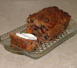 Sliced fruit-nut cake on a crystal serving dish
