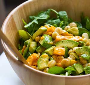 Arugula Mango Avo Mac Salad in a bamboo salad bowl
