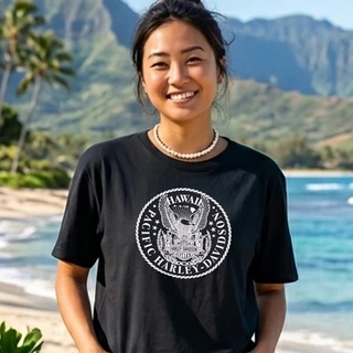 Front view of woman wearing black Harley-Davidson Aloha Crest Boxy T-Shirt on Hawaiian beach