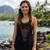 Front view of a smiling woman on a rocky Hawaiian beach wearing the black Harley-Davidson Women's Shaka G Tank Top