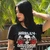 Front view of a woman outdoors near tropical greenery wearing the black Harley-Davidson Women's Angel Eyes Tee