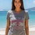 Close-up of winged Harley-Davidson badge graphic and V-neckline on women's grey shirt