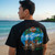 Rear view of Harley-Davidson Men's Maui Tiki Ocean T-Shirt in Black displaying tropical beach and tiki back graphic