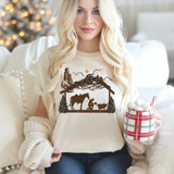Praying Manger DTF Heat Transfer, Christmas-themed Christmas nativity scene design on a woman's t-shirt.