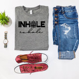 Inhale Exhale DTF Heat Transfer, gray t-shirt with black and cursive print design, showcasing a lotus flower and motivational words, paired with distressed blue jeans, red Converse sneakers, a wristwatch, and a small potted plant on white background.