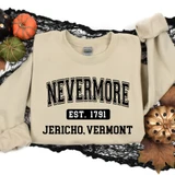 Nevermore Jericho DTF Heat Transfer, cream-colored sweatshirt with black text and design celebrating Jericho, Vermont, displayed on a black decorative background with pumpkins and autumn leaves.