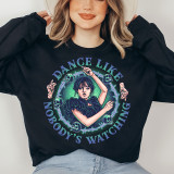 Dance Like Nobody's Watching Screen Print Heat Transfer, person wearing a black sweatshirt with a colorful graphic design of a woman surrounded by skulls and barbed wire, emphasizing the phrase 'Dance Like Nobody's Watching'.