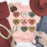 Blake Candy Hearts DTF Heat Transfer, colorful candy heart designs with various sayings on a pink T-shirt surrounded by fashion accessories.
