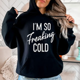 I'm So Freaking Cold WHITE DTF Heat Transfer, product image showing a woman wearing a black hoodie with white text design.