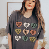 Conway Candy Hearts DTF Heat Transfer, colorful heart-shaped designs with playful phrases on a woman's T-shirt.