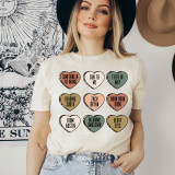 Bryan Candy Hearts Screen Print Heat Transfer, close-up view on a woman's t-shirt with colorful heart-shaped designs with text