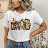 Cow Lattes DTF Heat Transfer, colorful graphic design of coffee cups with cows and sunflowers on a woman's T-shirt