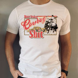 Busy Doing Cowboy Shit Screen Print Heat Transfer, graphic t-shirt featuring a cowboy riding a bucking horse with western landscape background.