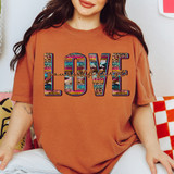 Love Yourself First DTF Heat Transfer, colorful and patterned text design on a woman's burnt orange t-shirt.
