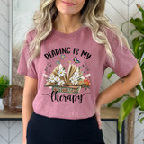 Reading Is My Therapy DTF Heat Transfer, colorful design featuring an open book with flowers and butterflies on a pink t-shirt.