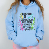 Remember All Glow Sticks Must Break Before They Can Shine, DTF Heat Transfer, folded brightly colored glow sticks and text on a light blue hoodie.